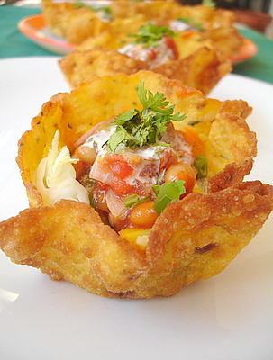 Mexican tacos with vegetable-baked beans filling topped with salsa and sour cream